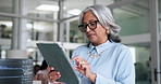 Mature woman, software developer and research with tablet in office for troubleshooting app or UI. Female person, employee or scrolling with conern on technology for web error, mistake or system fail