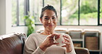 Coffee, smile and face of woman on sofa in home for relax, wellness drink and self care. Happiness, weekend break and comfortable with female person and herbal tea in living room of apartment