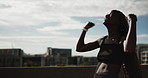 Celebration, fist pump and watch with woman runner outdoor on bridge for achievement or milestone. Blue sky, exercise and time with happy athlete cheering for fitness, running success or training