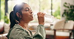 Wellness, laugh and woman drinking water in home for natural nutrients, thirsty and digestion. Flare, bottle and person with liquid beverage in morning for gut health, hydration or detox in apartment