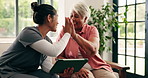 High five, tablet and old woman with caregiver on sofa, health assessment results and celebrate wellness. Positive feedback, elderly care and happy people with tech in home, laugh or checkup success