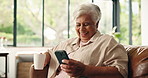 Coffee, laugh and elderly woman with phone in home for relax, social media or thinking in retirement. Tea, smile and senior person with mobile for reflection of funny meme, comedy or online post