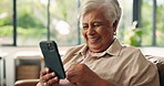 Smile, old woman and video call with phone at house for discussion, contact and virtual chat. Happy, senior person and mobile for conversation, blowing kiss and waving goodbye for networking on couch