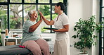 Physiotherapist, high five or old woman with tablet in clinic, smile or dumbbell exercise for healing success. Celebrate recovery, checkup or senior person with specialist for rehab, weights or tech