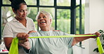 Elderly woman, physiotherapist and resistance band at clinic for recovery, stretching and muscle wellness. People, smile and excited with rehabilitation for injury, support or talk in retirement