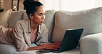 Freelancer, typing and woman with laptop, lounge and creative for article on website and journalism. Reporter, online and person with tech for research on couch, editing and remote work in house