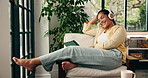 Woman, laugh and headphones in house with tablet, watch funny movie and entertainment on weekend break. Mature person, smile and audio in home with tech, comedy film and streaming service for series.