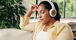 Relax, woman or thinking with headphones on sofa for nostalgic music, calm podcast or weekend break. Thoughtful, person or streaming audio in home for peaceful morning, memory or audiobook reflection