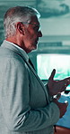 Discussion, surveillance and businessman in control room for review or feedback at agency. Professional, meeting and mature male supervisor in office with talking for security inspection in workplace
