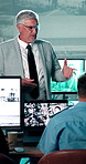 People, presentation or talk in security agency with computer screen, safety training or mentorship. Management, team and chat in control room with CCTV surveillance tech, workshop or system insight.