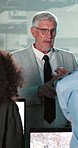 Talking, surveillance agency or man in control room, presentation or feedback in meeting. Mature person, security guard or supervisor in office, conversation or computer screen with safety inspection