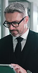 Walking, man and typing with tablet in office for trading platform, stocks performance or research. Trader, mature person and tech with glasses for investment news, monitor market and industry trends