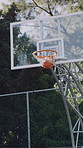 Basketball, net and score outdoor for game, court and points for competition, sports and achievement. Shooting, hoop and win for match, action and successful target in university, tournament or event