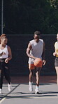 Running, friends and people with ball on basketball court, outdoor activity and training for team game. Fitness, space and group with equipment for dribbling practice, exercise club and play together