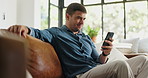 Smile, man and relax with phone at house for social media, browsing website and online news. Happy, male person and mobile for reading ebook, download games and message notification for weekend break