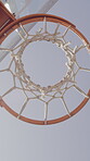 Sports, below and net outdoor for basketball, hoop fabric and equipment for practice session. Low angle, clear sky and ring setup on court for workout activity, rim and game training in fitness hobby