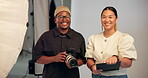 Camera, creative and face of director with photographer in studio for collaboration or shoot. Art, photography or production with man and woman on set together for bts teamwork or catalog session