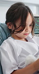 Girl, patient and playing with teddy bear on hospital bed for medical checkup or healthcare service. Child, kid or playful with stuffed animal for emotional comfort or distraction in clinic room