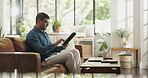 Tablet, freelancer and scroll with man on sofa for blog writer, virtual editor and newsletter promotion. Online magazine article, remote worker and email marketing with person in living room of home