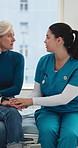 Nurse, patient and holding hands in hospital with conversation, bad news and empathy for diagnosis. Mature woman, healthcare worker and talk in clinic with support, trust or comfort for test results.