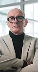 Face, business and man in office, arms crossed and investor with confidence, glasses and pride. Mature person, corporate professional and financial advisor in workplace, career ambition and trader