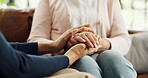 Caregiver, holding hands and people in home with trust, understanding or empathy in retirement care. Compassion, security or elderly person in house with comfort, support and  in assisted living.