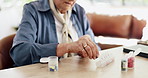 Hands, old woman and organize pills at house for daily dosage, medicine routine and prescription. Senior person, tablets and container for weekly planner, pharmaceutical reminder and chronic illness 