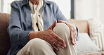 Hands, massage and knee pain with senior person on sofa in living room for arthritis or osteoporosis. Inflammation, joint injury and rubbing with old woman in home for recovery or rehabilitation