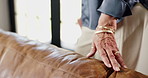 Woman, sofa and touch with hand for interior design, material quality and fabric texture. Mature person, couch and home designer with furniture inspection, review product and check comfort at house