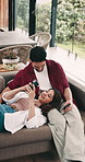 Happy, couple and conversation on sofa with phone for social media, online news or bonding together. Married people, smile or tech in home for browsing internet, discussion or relax on weekend break.