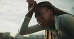 Fitness, fatigue and black woman in city for break, wellness or exhausted from intense workout. Person, sweat or tired runner rest after training challenge, exercise or breathing for health with pain