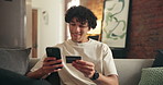 Happy man, credit card and ecommerce on couch in home with easy payment, bills or budget for transaction. Person, smartphone and mobile app for online shopping, fintech and digital banking at house