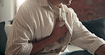 Hands, man and discomfort of chest pain at house for heart attack, lung infection and pressure. Person, symptoms and cardiac emergency of respiratory distress, rapid heartbeat and shortness of breath