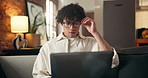 Glasses, laptop and remote work with man on sofa in living room for online planning or review. Computer, reading and research with employee in home for small business freelance or startup career