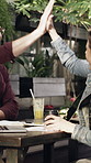 High five, phone call and remote work with people in coffee shop for small business success. Conversation, good news and startup with freelance team at outdoor cafe or restaurant for deal celebration