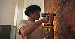 Brick wall, man and drill in home for renovation, DIY or maintenance with repair. Equipment, person and electric machine for drilling, house upgrade or improvement with safety goggles for remodeling