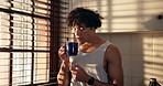 Reflection, aroma and man with coffee in kitchen for peace, smile and daydream with drink in home. Smell, thinking and happy person with tea in apartment for calm, start day or enjoy view by window