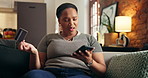 Credit card, mistake and black woman on sofa with phone for online shopping, transaction fail and error. Home, confused and person on bank app for ecommerce, payment issue and glitch for digital sale