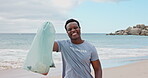 Excited, face and man with trash, beach and cheering for social responsibility, cleaning or recycle. Sea, black person and waste management for community service, laughing and volunteering in nature