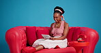 Woman, online and laughing with tablet, studio and editing video for social media or blue background. Happy, influencer and black person with tech for content creation, creative and submission on app