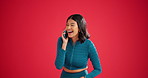 Girl, phone call and wow with laugh in studio for fake news, story or gossip on red background. Woman, tech and surprise for conversation on app with headline, controversy and space or social media