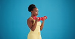 Studio, black woman and workout with dumbbells for fitness, exercise or health on blue background. Curl, weightlifting and strength training with person for bicep muscle, bodybuilder and mockup space