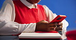 Phone, hands and businesswoman in studio for networking, contact or texting on mobile app. Technology, connectivity and female creative editor on cellphone for communication by blue background.