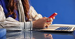 Phone, hands and businesswoman in studio for texting, contact or networking on mobile app. Technology, connectivity and female creative editor on cellphone for communication by blue background.
