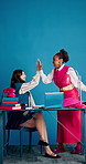 Happy women, business and laptop with high five for winning, success or good news in office. Excited, female people or employees with smile on computer for teamwork, promotion or achievement together