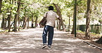 Park, dancing and happy man with headphones for commute, streaming radio channel and music playlist. Outdoor, listen and black person with audio tech for travel, positive attitude and groove to song