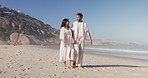 Love, walk and couple holding hands by sea for care, support and talk to partner on vacation. Connection, man and woman travel at beach for summer holiday, smile and romance on tropical island
