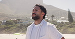 Thinking, man and breathing at beach for travel, adventure and daydreaming with peace on holiday. Smile, male person and mindfulness with reflection, fresh air and sightseeing view on vacation at sea