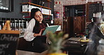 Waitress, woman and phone call in restaurant with tablet, booking website and app for online order. Person, scroll and discussion in diner with tech, contact and reservation for customer service.