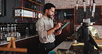 Management, planning and tablet with man in coffee shop for agenda or online booking schedule. App, inventory and scrolling with manager in cafe or restaurant for small business or startup checklist